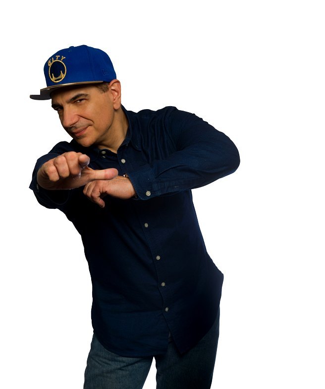St. John pointing at the camera in a Warriors cap